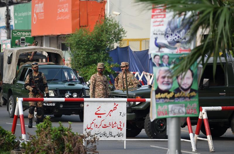 Pakistani soldiers stand outside a polling station ahead of the arrival of Shabaz Sharif at a polling station in Lahore. AFP