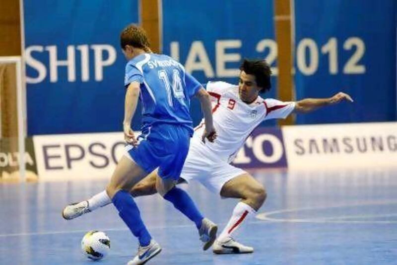 Shamsaee Vahid, the Iran captain and forward, in white, battles for the ball with Uzbekistan’s Svirido Konstantin