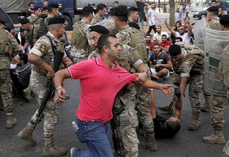 Lebanese army soldiers remove protestors blocking the main road between the southern city of Sidon and the capital Beirut. aFP