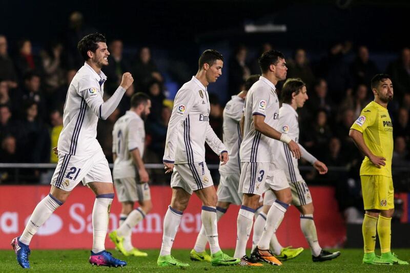 Real Madrid forward Alvaro Morata left, celebrates after scoring the winner against Villarreal. Biel Alino / AFP