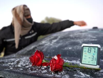 Rukna Region, Al Ain, United Arab Emirates, January 11, 2021. Fahad Mohammed of the UAE Storm Centre scrapes off some ice build up on a car during low temperatures at Rukna region, Al Ain which went down to -4 degrees Celsius  at one point.                     
Victor Besa/The National
Section:  NA
Reporter:  Haneen Dajani