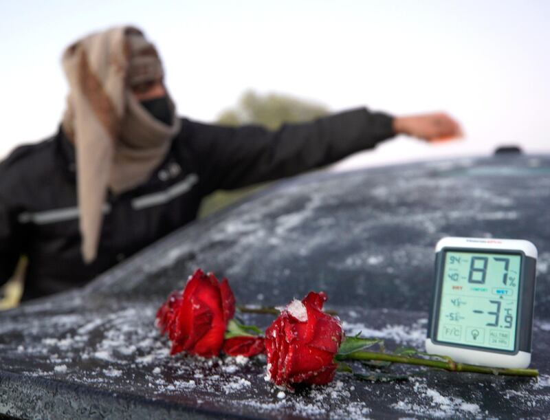 Rukna Region, Al Ain, United Arab Emirates, January 11, 2021. Fahad Mohammed of the UAE Storm Centre scrapes off some ice build up on a car during low temperatures at Rukna region, Al Ain which went down to -4 degrees Celsius  at one point.                     
Victor Besa/The National
Section:  NA
Reporter:  Haneen Dajani