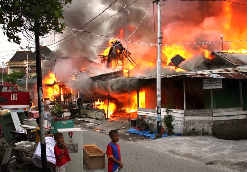 A house burns in Padang after a 7.6 magnitude earthquake struck off the west coast of Indonesia's Sumatra island in September 2009, killing about 200