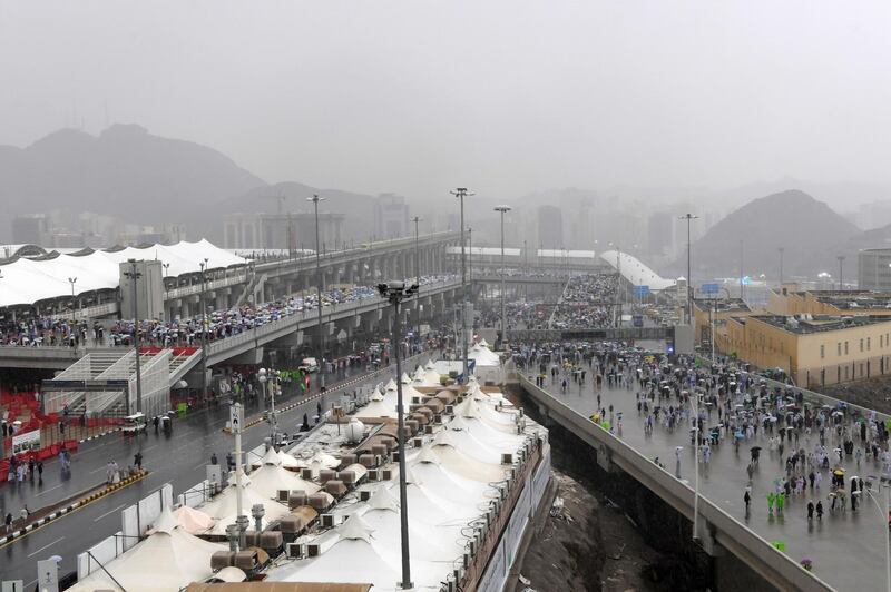 Muslim worshippers arrive in Mina under heavy rain to throw pebbles as part of the symbolic Jamrat Al Aqabah. AFP