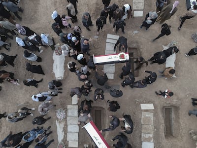 Mourners at a mass funeral in 2021 for Yazidi victims of ISIS whose remains were found in a mass grave. AFP