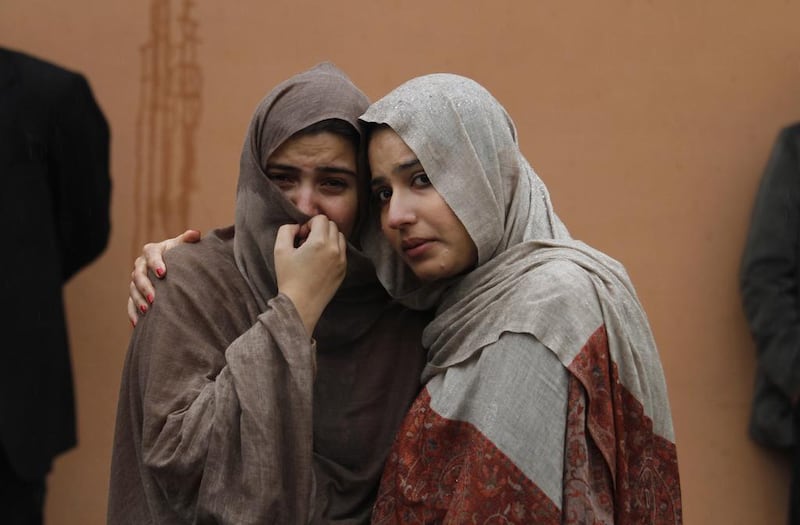 Pakistani women mourn outside a hospital’s morgue, where the bodies of victims of a twin suicide bombing are, in Islamabad, Pakistan on Monday, March 3, 2014. Anjum Naveed / AP Photo