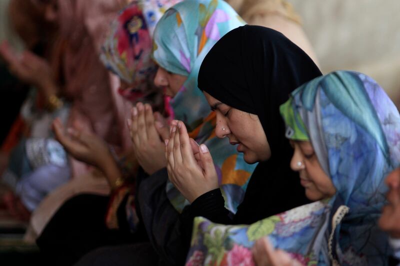 Women offer prayers during the first Friday of Ramadan at the historic Badshahi mosque, in Lahore, Pakistan. AP