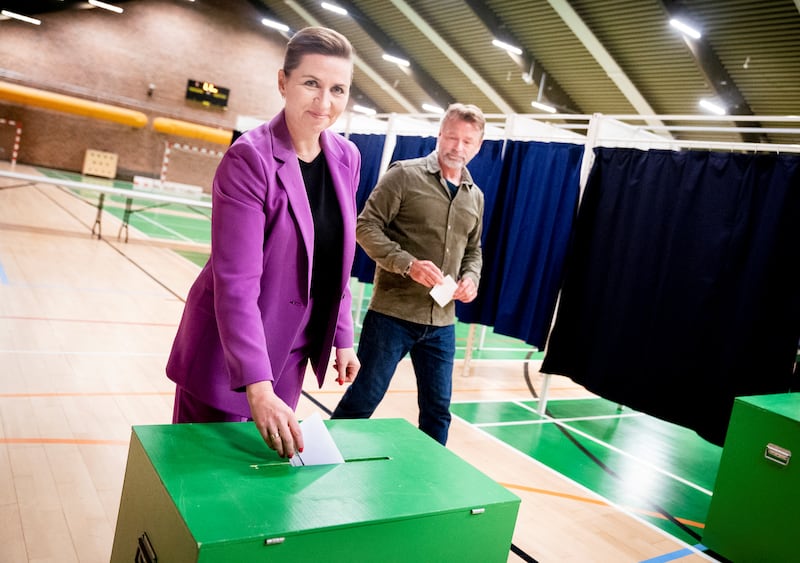 Danish Prime Minister Mette Frederiksen and her husband Bo Tengberg vote in the referendum. Reuters