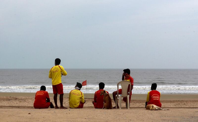Lifeguards sit at the Juhu beach on the Arabian Sea coast in Mumbai, India. AP Photo