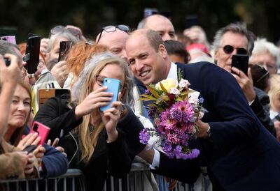 Prince William poses for a selfie as he chats with mourners outside Norwich Gate on the Sandringham Estate. AFP