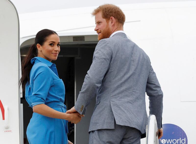Britain's Prince Harry and Meghan, Duchess of Sussex look on before departing from Fua'amotu International Airport in Tonga. Reuters