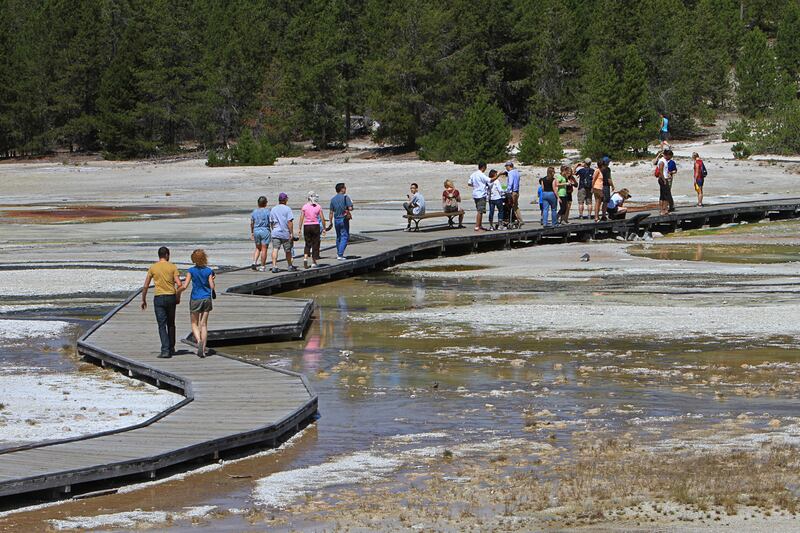 Visitors walk through the Norris Geyser Basin in Yellowstone National Park, Wyoming. National Park Service via AP