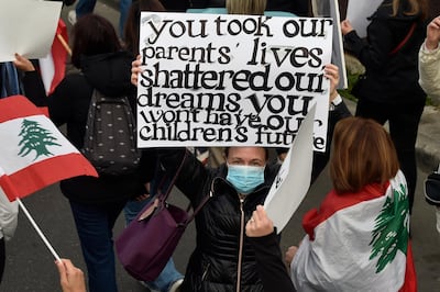 epa09086253 Lebanese women carry placards as they march on the occasion of Motherâ€™s Day under the slogan 'Mother's Cry', in Beirut, Lebanon, 20 March 2021. Mother's Day is celebrated in various countries on 21 March.  EPA/WAEL HAMZEH