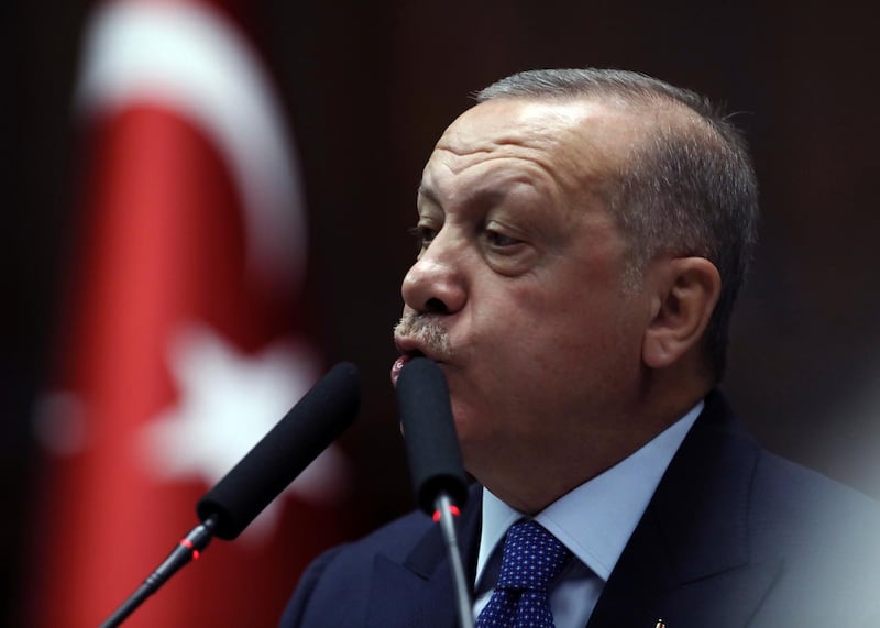 Turkish President Recep Tayyip Erdogan addresses his ruling party legislators at the Parliament, in Ankara, Wednesday, Oct 16, 2019. Erdogan called Wednesday on Syrian Kurdish fighters to leave a designated border area in northeast Syria 'as of tonight' for Turkey to stop its military offensive, defying pressure on him to call a ceasefire and halt its incursion into Syria.(AP Photo/Burhan Ozbilici)