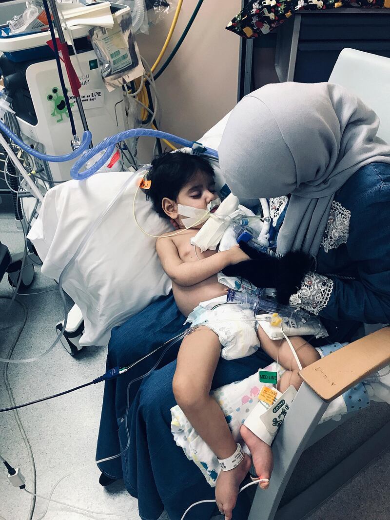 In this Wednesday, Dec. 19, 2018, photo released by the Council on American-Islamic Relations, Sacramento Valley, Shaima Swileh holds her dying 2-year-old son Abdullah at a hospital in Oakland, Calif. Swileh, a Yemeni mother who fought for the right to see her dying son, arrived Wednesday night after the Trump administration gave her a long-sought waiver to its travel ban. (Council on American-Islamic Relations, Sacramento Valley via AP)