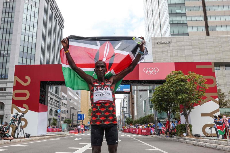 Kenya's Eliud Kipchoge celebrates after winning  the men's marathon.