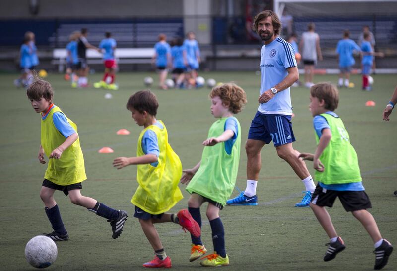 Italian international Andrea Pirlo plays with young soccer players while visiting a soccer camp after being introduced by Major League Soccer (MLS) club New York City FC as their newest player, at an event in New York, July 23, 2015. The 36-year-old former Juventus and Milan player will join New York City FC for the rest of 2015 season as their third Designated Player. REUTERS/Mike Segar