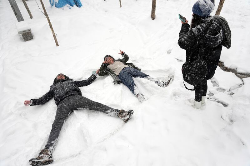 Snow angels in Tehran. Rare heavy snowfall and cold weather across Iran have led to a shortage of natural gas for households and factories. AP