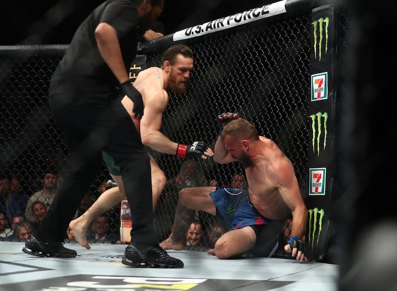 Conor McGregor pins Donald Cerrone against the cage. Reuters