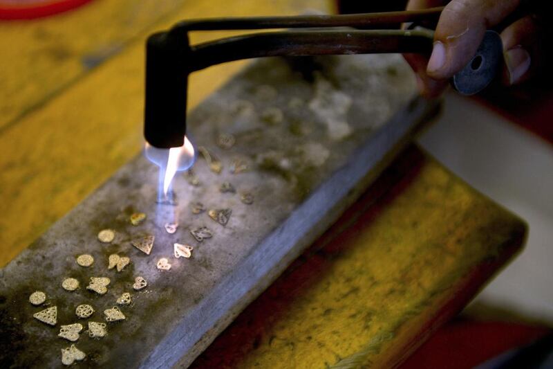 A craftsman makes gold accessories for jewellery in Antioquia. Colombia produces some 66 metric tonnes of gold a year, or about US$33billion in exports. Raul Arboleda / AFP