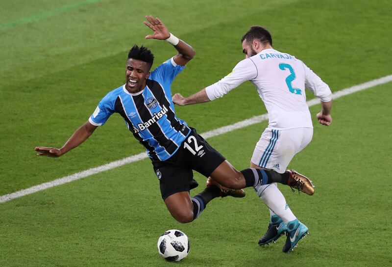 Real Madrid’s Dani Carvajal brings down Gremio’s Cortez with a hard challenge. Ahmed Jadallah / Reuters