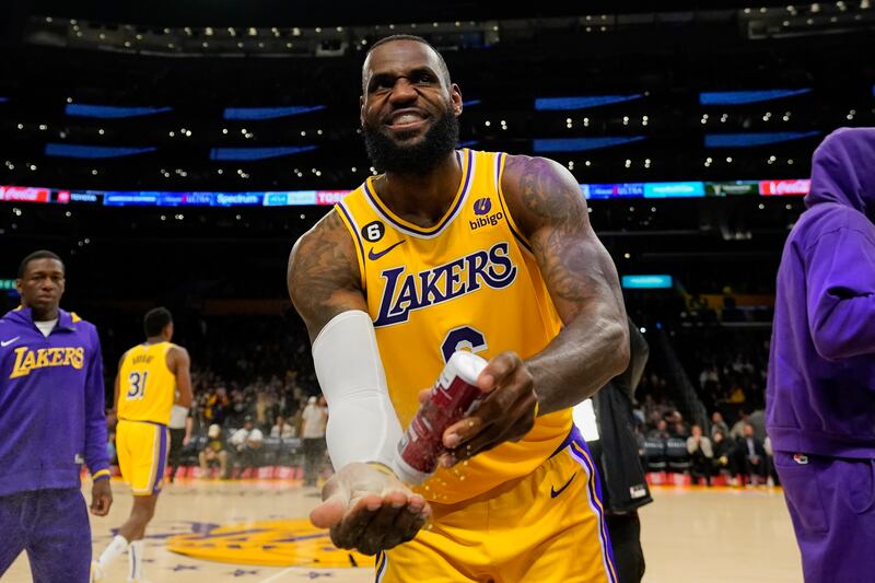 LA Lakers forward LeBron James puts powdered chalk on his hands before the game against the Sacramento Kings. AP
