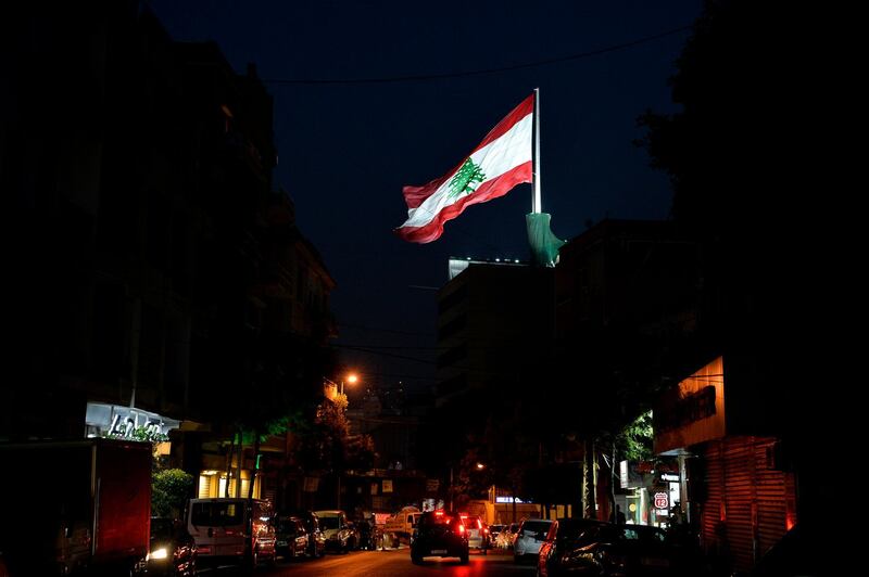 A giant Lebanese flag flutters above a residential building at Bourj Hammoud neighborhood in Beirut, Lebanon. EPA