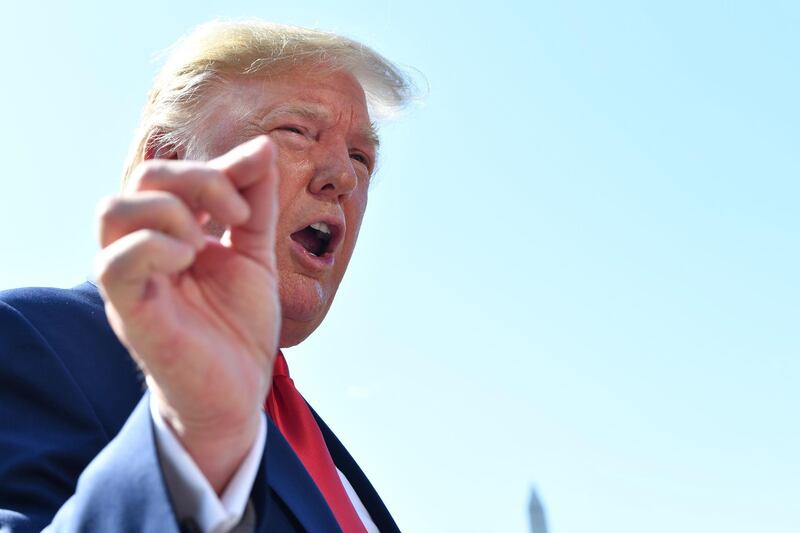 US President Donald Trump gestures as he speaks to the press on the South Lawn of the White House before departing in Washington, DC on August 9, 2019. US President Donald Trump departed the White House for fundraisers in New York before going to his summer holidays in Bedminster, New Jersey. / AFP / Nicholas Kamm
