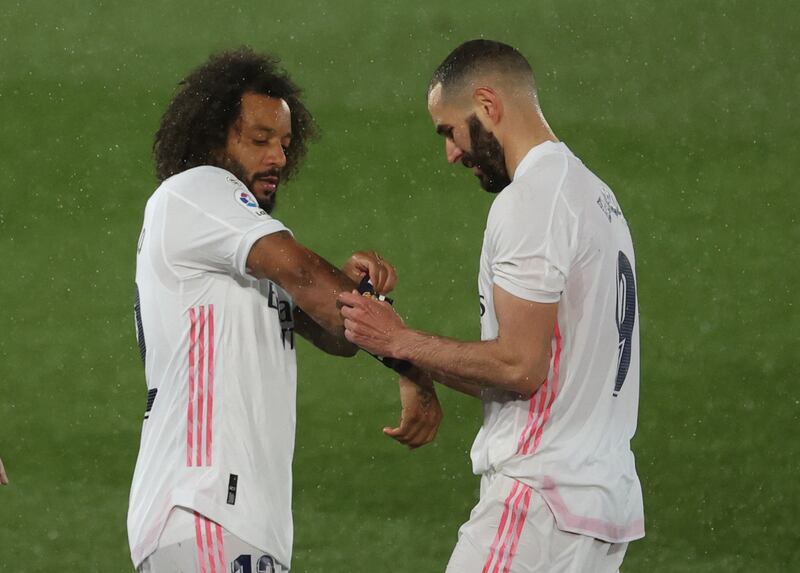 Real Madrid's Marcelo takes on the captain armband from teammate Karim Benzema as he leaves the pitch. EPA