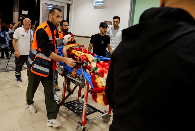 An injured man is transported on a stretcher at a hospital in Jenin. Reuters