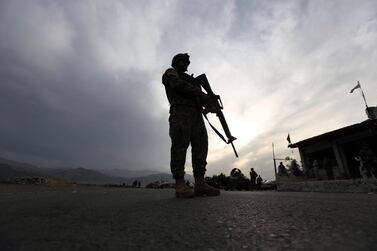 An Afghan National Army (ANA) soldier stand guard at a check point in Jalalabad-Kabul highway, east of Kabul, Afghanistan, Saturday, April 4, 2020. (AP Photo/Rahmat Gul)