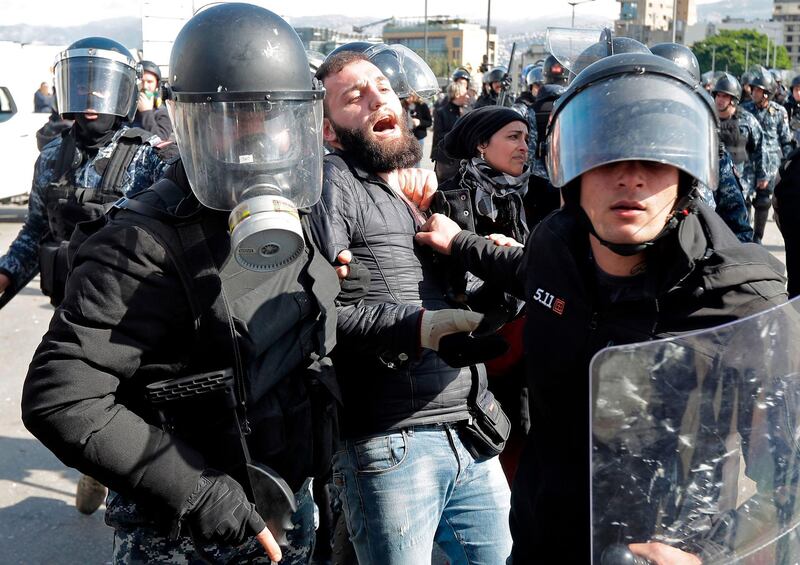 Lebanese security forces detain an anti-government protester during clashes in a demonstration in the centre of the capital Beirut.  AFP