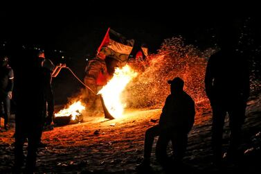 Palestinian protesters take part in a night demonstration near the fence along the border with Israel, in Rafah in the southern Gaza Strip, on March 19, 2019. The often violent protests are demanding Palestinian refugees and their descendants be allowed to return to former homes now inside Israel. Israeli officials say that amounts to calling for the Jewish state's destruction, and accuse Hamas, the Islamist movement that runs the Gaza Strip, of orchestrating the protests. / AFP / SAID KHATIB