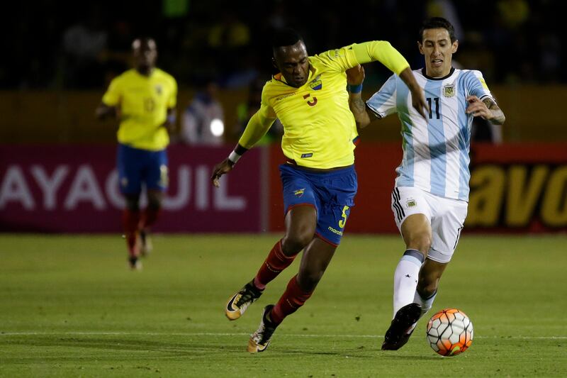 Argentina's Angel Di María, right, fights for the ball against Ecuador's Alex Ibarra. Fernando Vergara / AP Photo