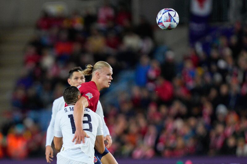 Erling Haaland competes for a header during Norway's match against Serbia. EPA