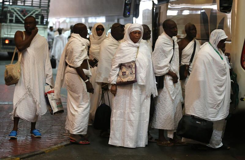 Muslim pilgrims line up to board a bus in Saudi Arabia's holy city of Mecca, bound for the tent-city of Mina, during the first day of the annual Hajj pilgrimage on August 19, 2018. - Muslims from across the world gather in Mecca in Saudi Arabia for the annual six-day pilgrimage, one of the five pillars of Islam, an act all Muslims must perform at least once if they have the means to travel to Saudi Arabia. (Photo by AHMAD AL-RUBAYE / AFP)