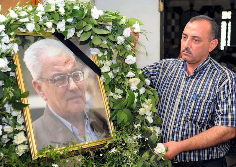 Mandatory Credit: Photo by Xinhua/Shutterstock (4989215a)
Mohammad al-Asaad stands next to the portrait of his late father, Khaled al-Asaad, a prominent Syrian archaeologist who was beheaded by the Islamic State (IS) terror group last week in the ancient city of Palmyra, during a memorial service at the Department of Museums and Antiquities in Damascus
Memorial service for murdered Syrian archaeologist Khaled al-Asaad, Damascus, Syria - 23 Aug 2015