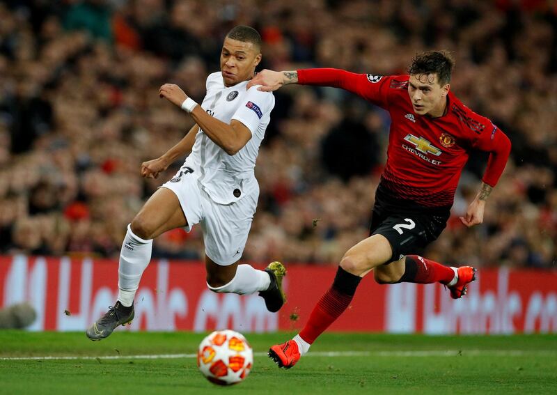 Paris Saint-Germain's Kylian Mbappe in action with Manchester United's Victor Lindelof. Reuters