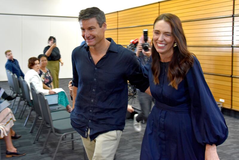 Ms Ardern with partner Mr Gayford after announcing her resignation at War Memorial Hall in Napier. EPA