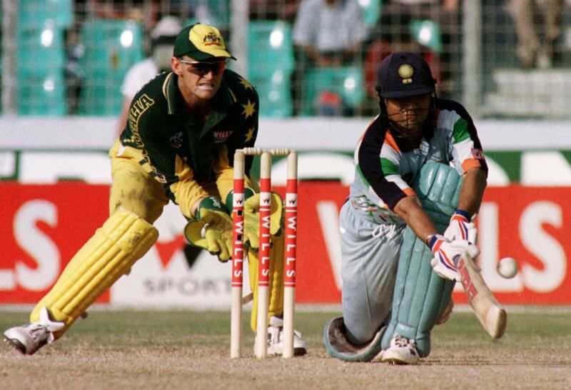 Australian wicketkeeper Adam Gilchrist (L) stands behind the stumps as Indian batsman Sachin Tendulkar (R) sweeps a ball off Damien Fleming in the quarter-final of the International Cup in Dhaka October 28. Tendulkar scored 141 before being run out. India finished their innings at 307 for eight in 50 overs.

AN/FY/JDP