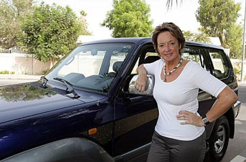 Pauline Redding poses proudly with her immaculate, 11-year-old Toyota Prado, which she prizes for its safety features, at her home in Jumeirah.