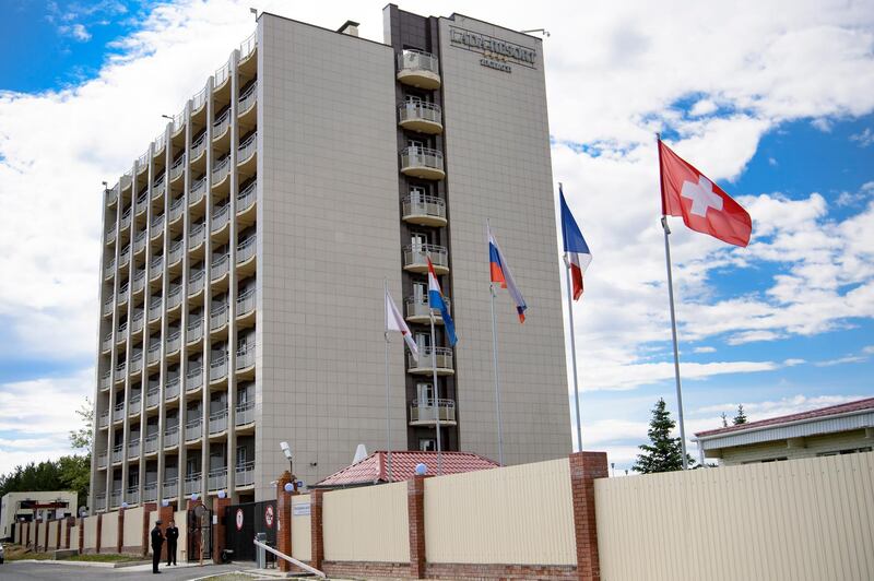 The Swiss flag is pictured in front of the Lada Resort Hotel, Switzerland's team base camp, in Togliatti, Russia. EPA