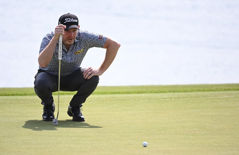 Scotland's Stephen Gallacher lines-up a putt on the 9th green on his way to an opening round 62 that left in second place on the leaderboard. Getty