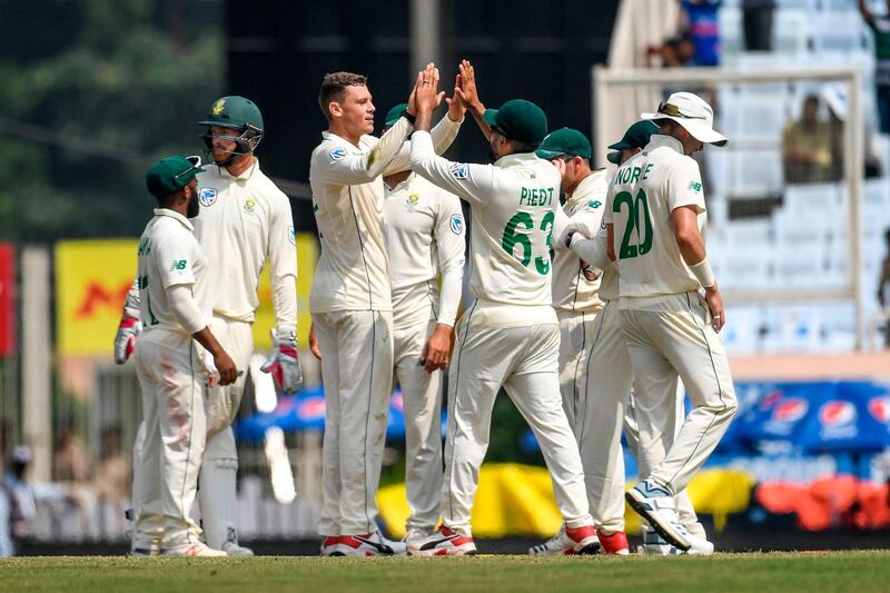 South Africa's George Linde celebrates with teammates after dismissing India batsman Ajinkya Rahane. AFP