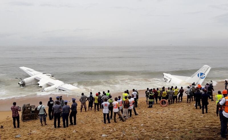 Policemen and rescuers stand near the wreckage of a cargo plane after it crashed in the sea near the international airport in Ivory Coast's main city, Abidjan. Luc Gnago / Reuters