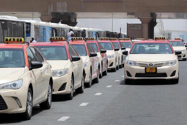 Dubai taxis parked along the road. Pawan Singh / The National