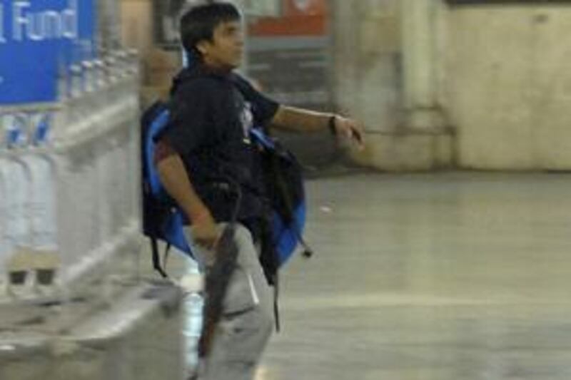 Mohammad Ajmal Kasab, the lone surviving gunman of the 2008 Mumbai attacks, walks on the premises of the Chhatrapati Shivaji Terminus or Victoria Terminus railway station in Mumbai, November 26, 2008.