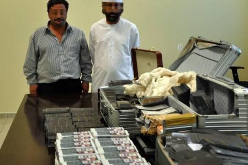 Provided photo of counterfeiting suspects 
December 5, 2010

The two suspects, an Emirati businessman and an Egyptian accountant, would have genuine dollar notes tinted with black. They would add chemicals to the note which would remove the black colour and keep the note. They would then tell their customers they could sell the powder which would turn any black paper into genuine dollar notes. 

Courtesy Abu Dhabi Police Dept. 