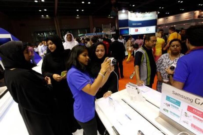 Dubai, United Arab Emirates- April, 03, 2013: Visitors takes a closer look at the latest Digital Camera at the Samsung store during the Gitex Shoppers-2013 at the Dubai World Trade Centre in Dubai .  (  Satish Kumar / The National ) For Business