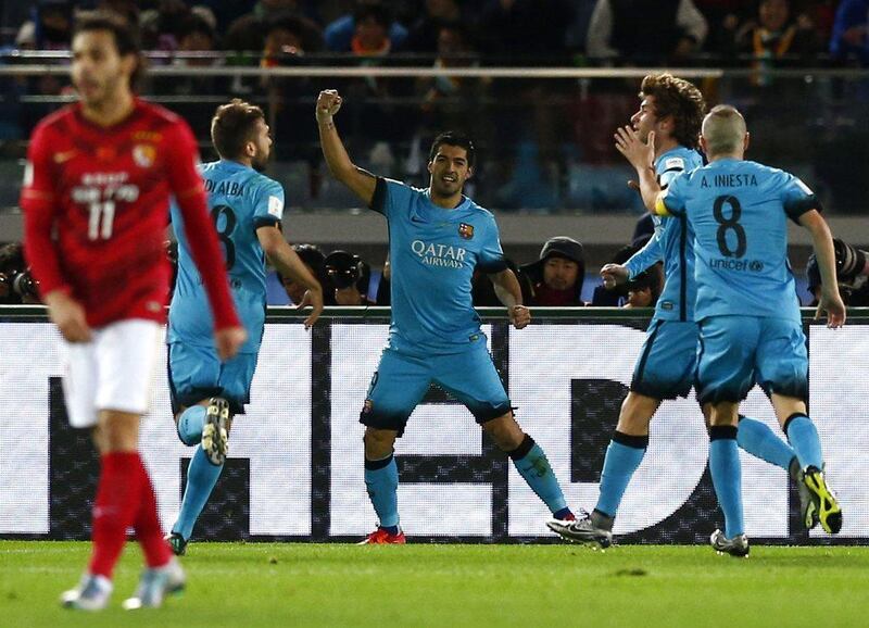 Luis Suarez, centre, celebrates with his teammates after scoring against Guangzhou Evergrande. Thomas Peter / Reuters